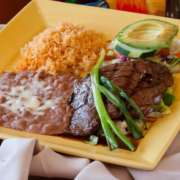 El Coronel Mexican Restaurant's carne asada with rice, refried beans, avocado, and green onions.